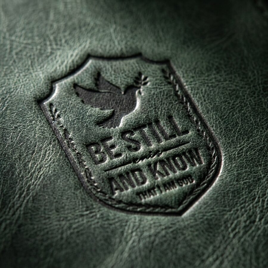 CGU-BKM-GREEN full-grain leather texture and debossed verse close-up