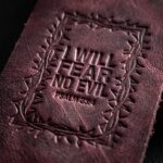 CGU-BKM-RED full-grain leather texture and debossed verse close-up