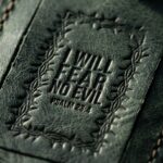 CGU-LUG-GREEN full-grain leather texture and debossed verse close-up