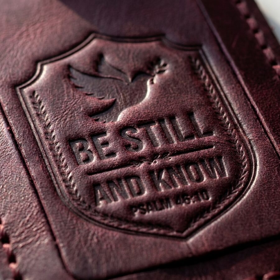 CGU-LUG-RED full-grain leather texture and debossed verse close-up