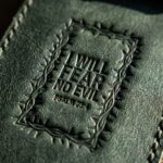 CGU-PEN-GREEN full-grain leather texture and debossed verse close-up