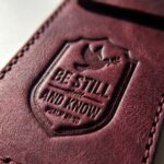 CGU-PEN-RED full-grain leather texture and debossed verse close-up