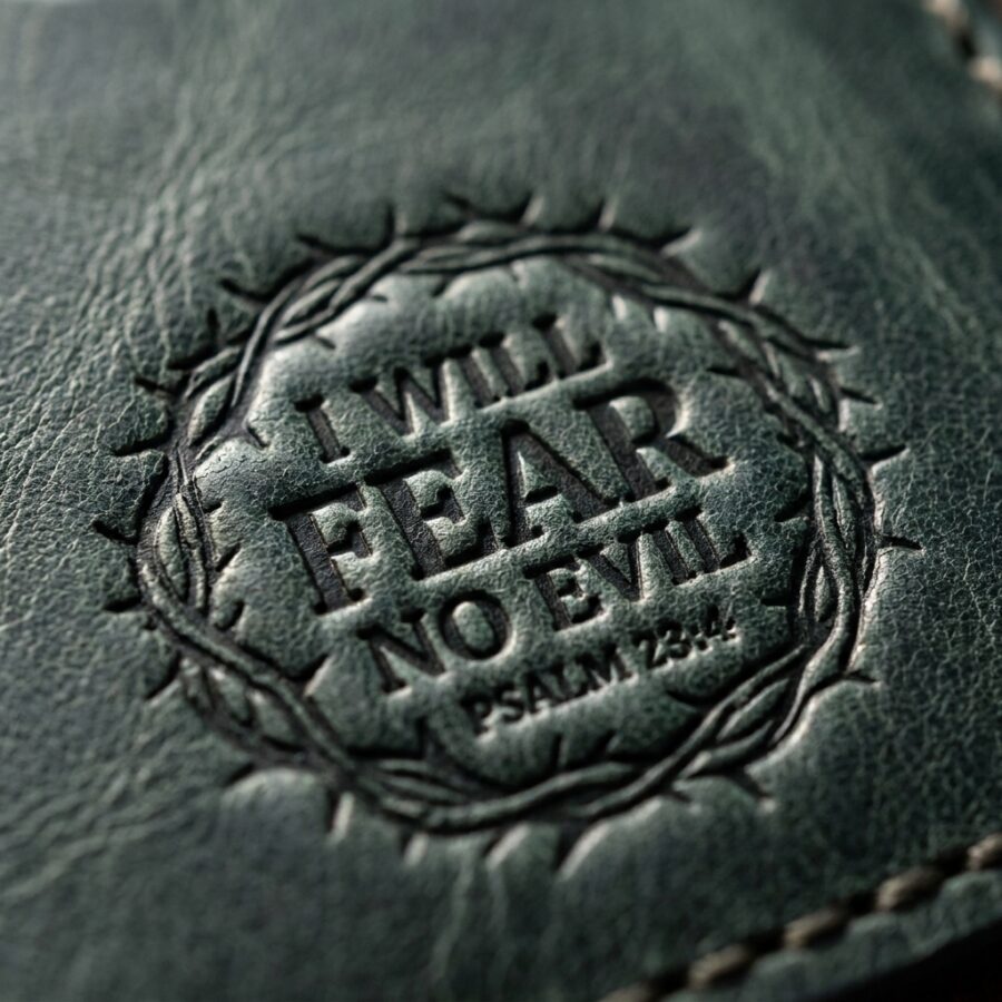 CGU-SCR-GREEN full-grain leather texture and debossed verse close-up