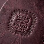 CGU-SCR-RED full-grain leather texture and debossed verse close-up