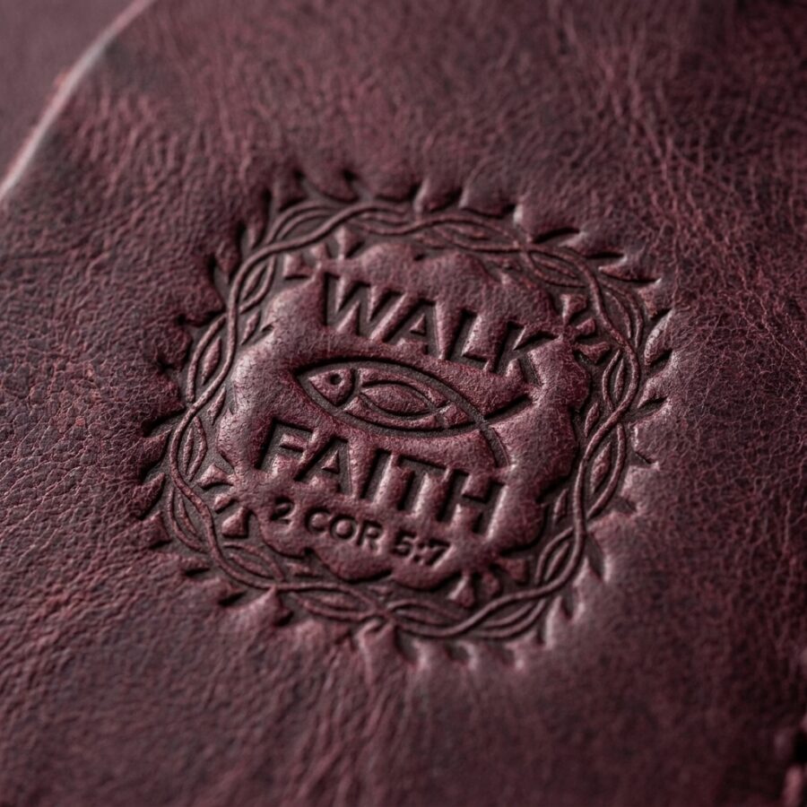 CGU-SCR-RED full-grain leather texture and debossed verse close-up