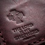 CGU-VCR-RED full-grain leather texture and debossed verse close-up