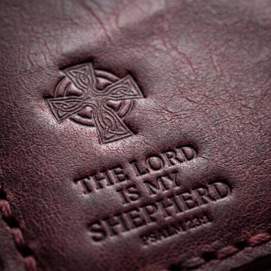 CGU-VCR-RED full-grain leather texture and debossed verse close-up